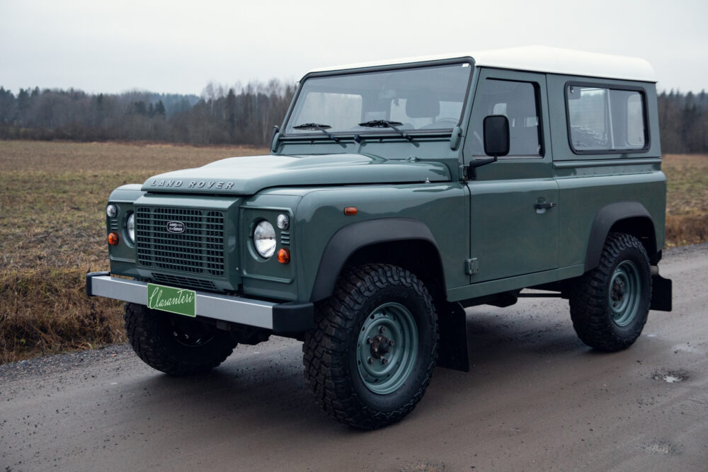 Land Rover Defender parked in open field