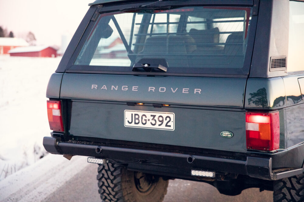 Range Rover parked in snowy landscape at dusk