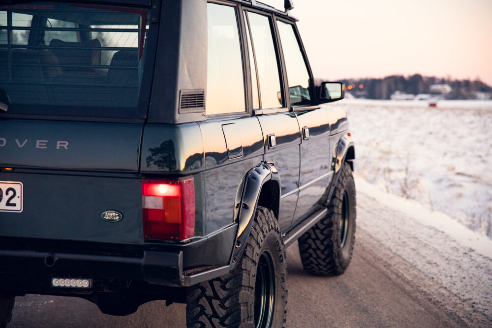 Land Rover on snowy road at sunset