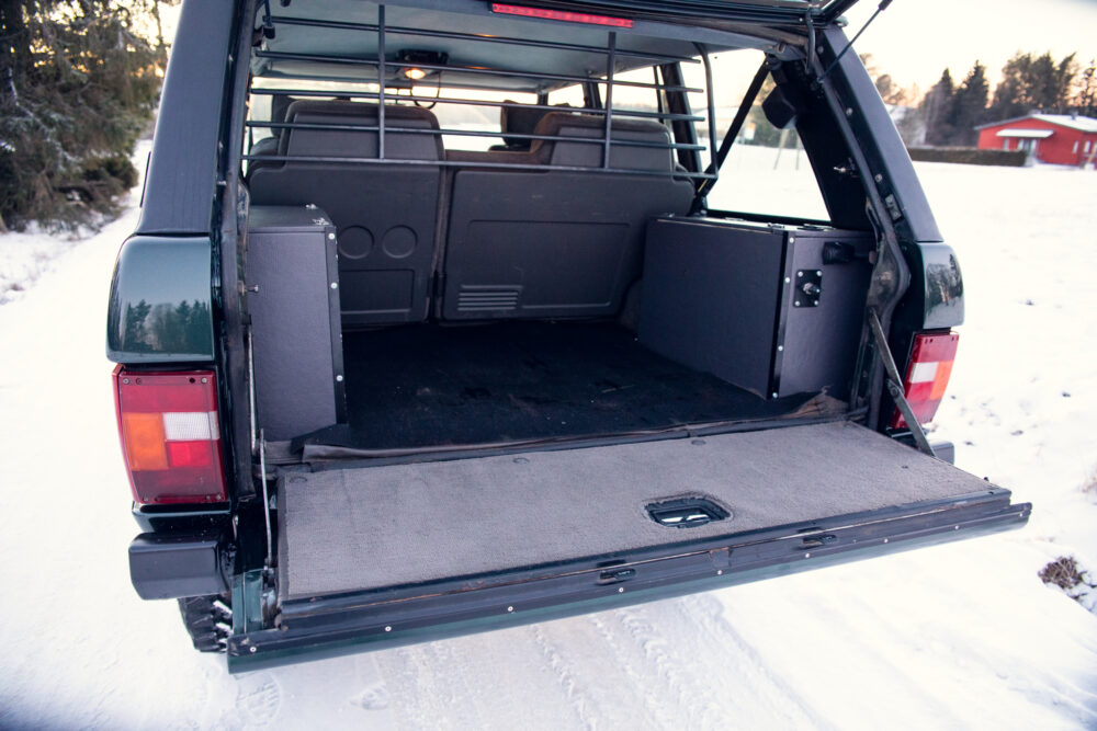 Open SUV trunk in snowy landscape