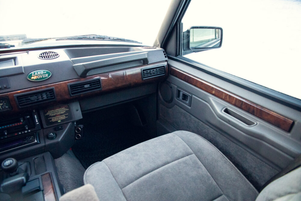 Interior of vintage Land Rover with wood trim dashboard