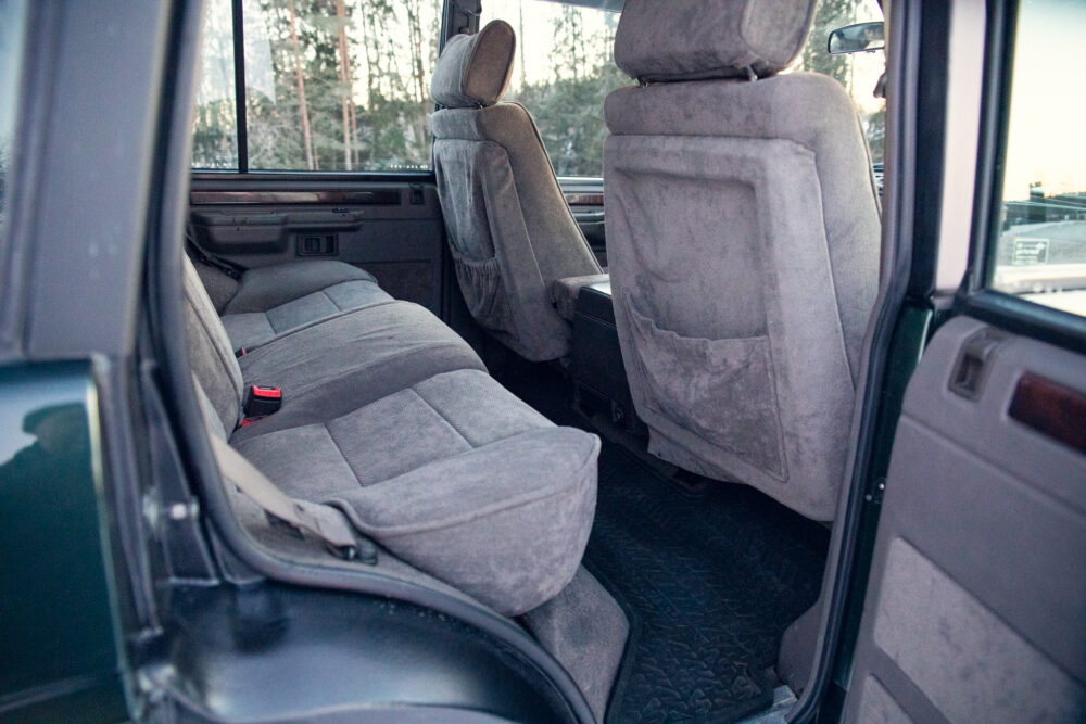 Interior view of an older gray van with seats