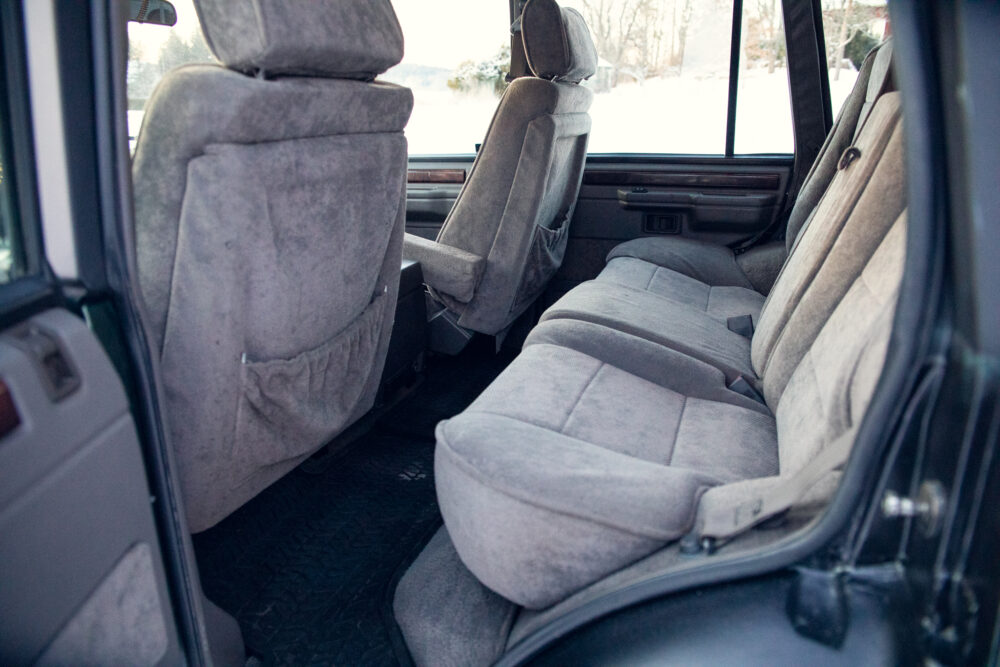 Interior of van with gray fabric seats, open door