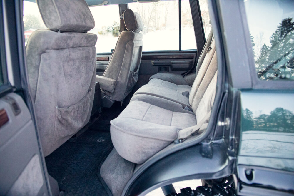Interior view of an old, grey minivan seating