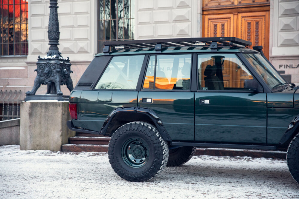 Dark green SUV near historical building in winter