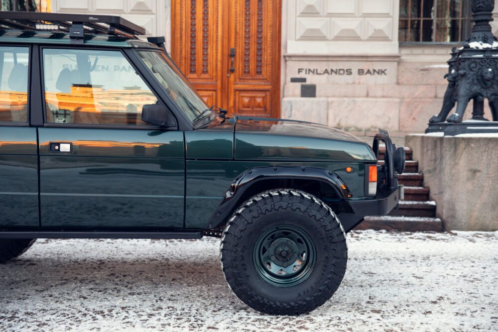 Green off-road vehicle parked near Finland's Bank