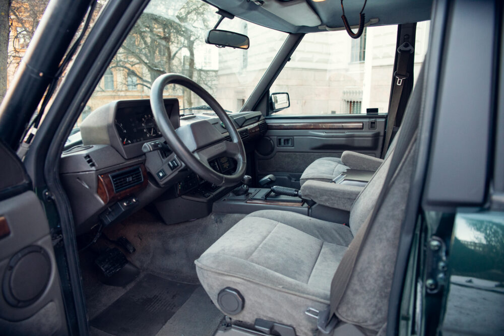 Vintage car interior with grey seats and dashboard
