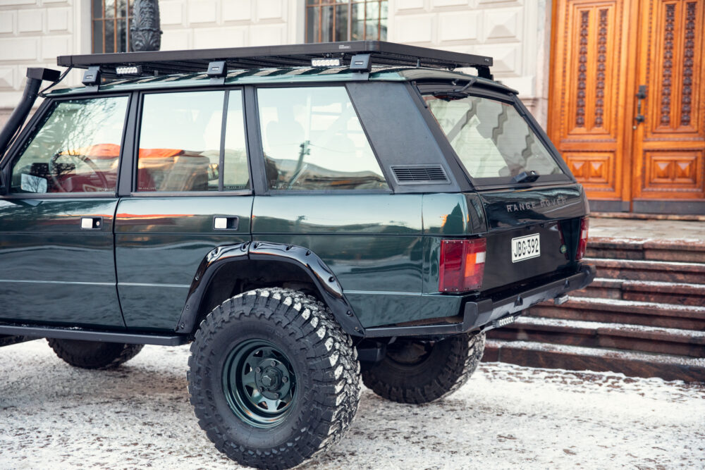 Vintage Range Rover parked on snowy steps