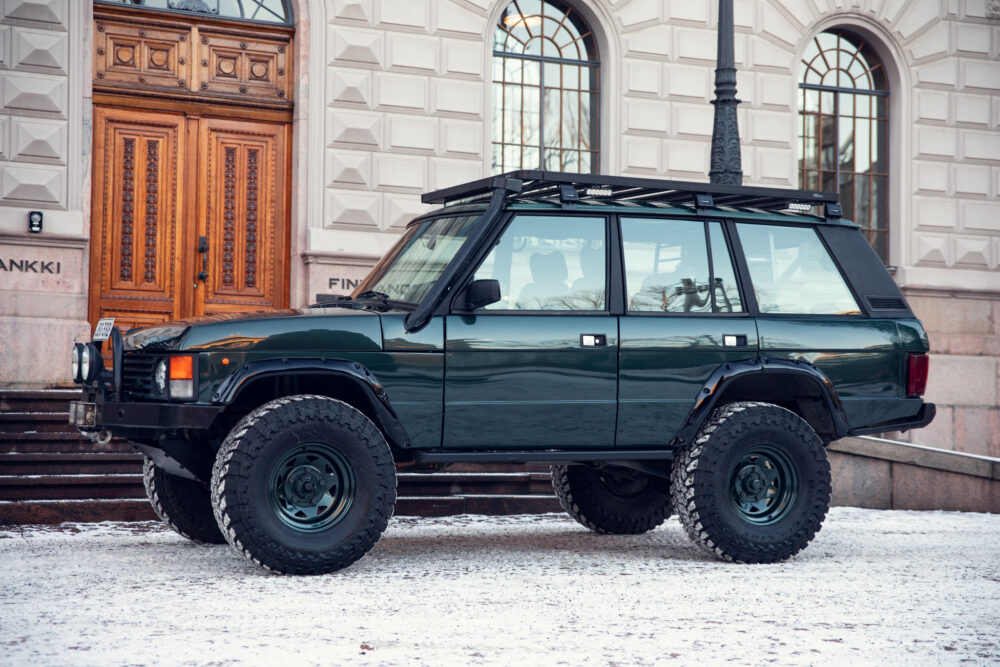 Green off-road vehicle parked on snowy street
