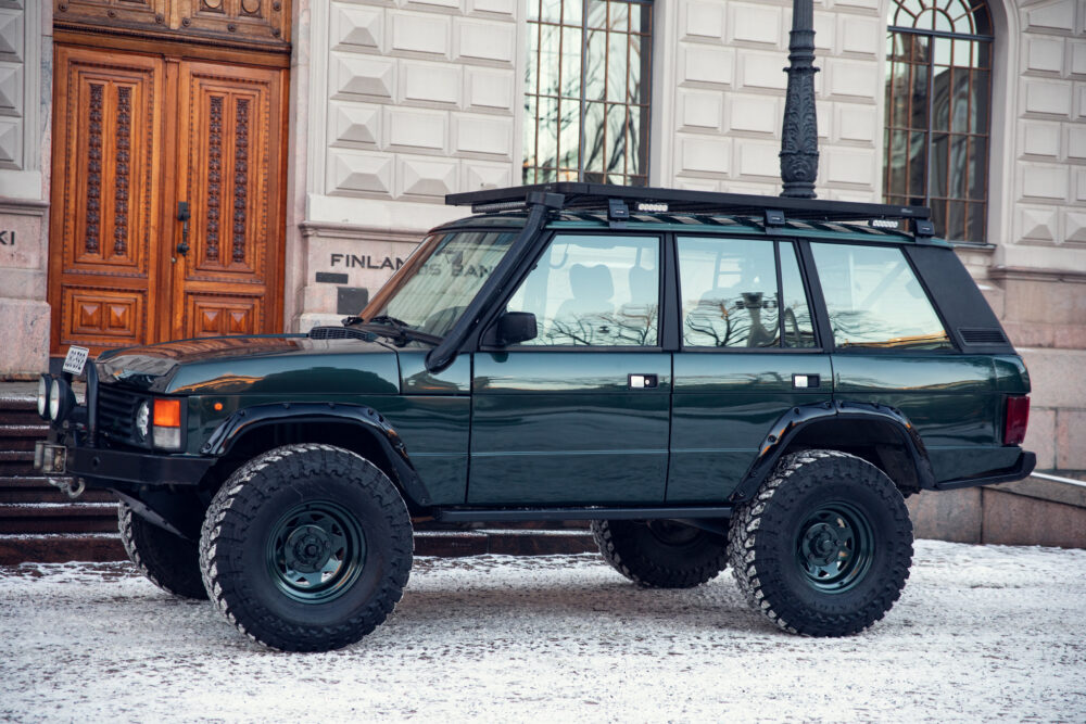 Dark green off-road SUV parked on snowy street