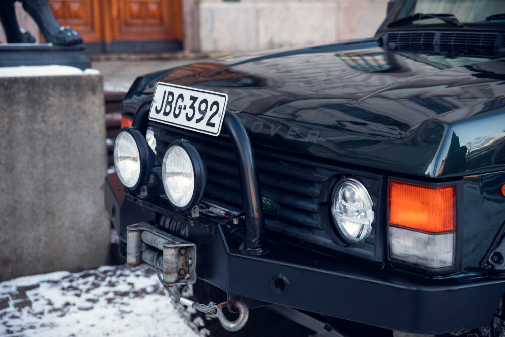 Black vintage Land Rover with registration plate JBG-392