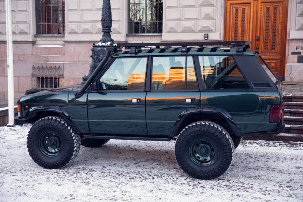 Dark green off-road SUV parked on snowy street