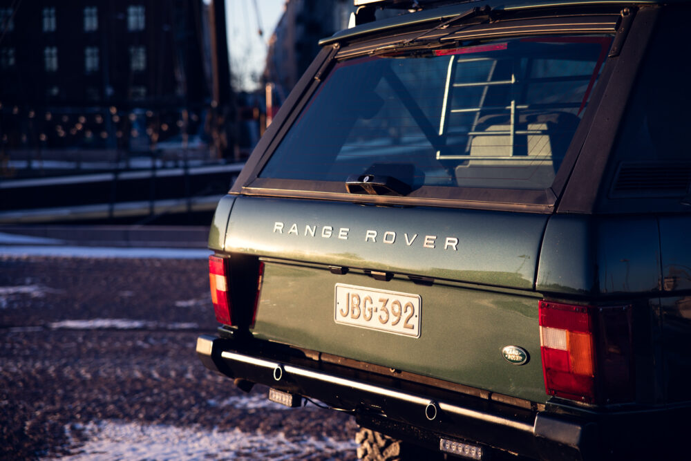 Vintage Range Rover parked in urban evening light