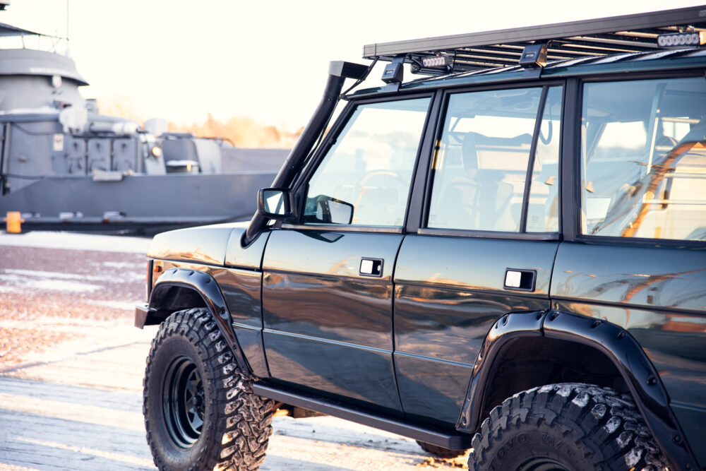 Modified off-road vehicle near a naval ship