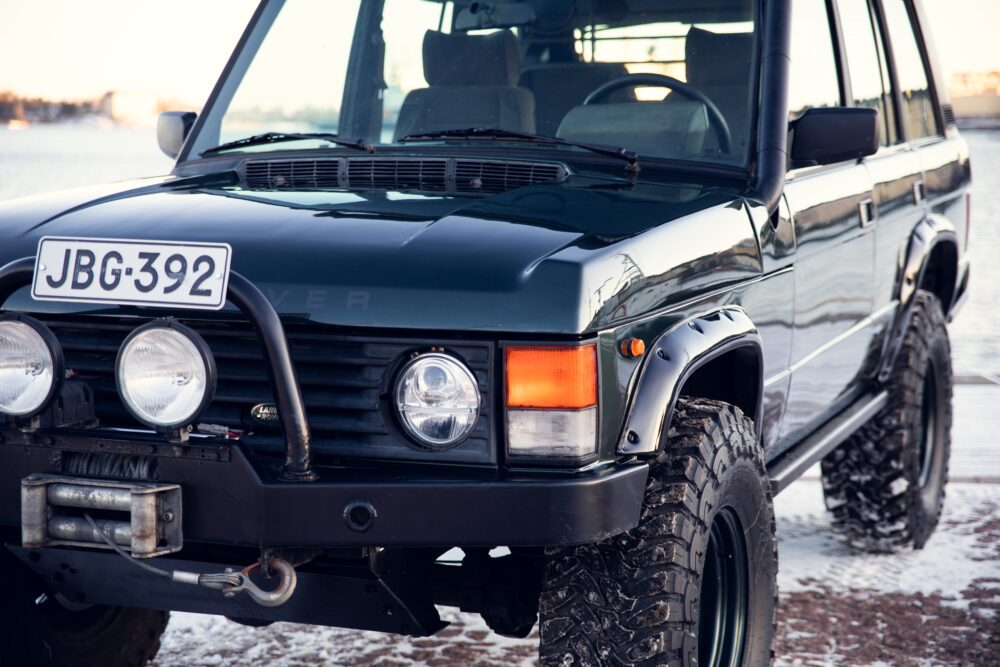 Black Land Rover at snowy waterfront