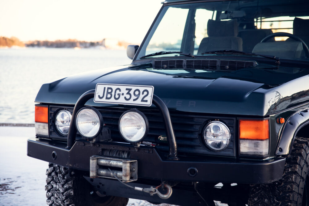 Black Range Rover near lake during sunset