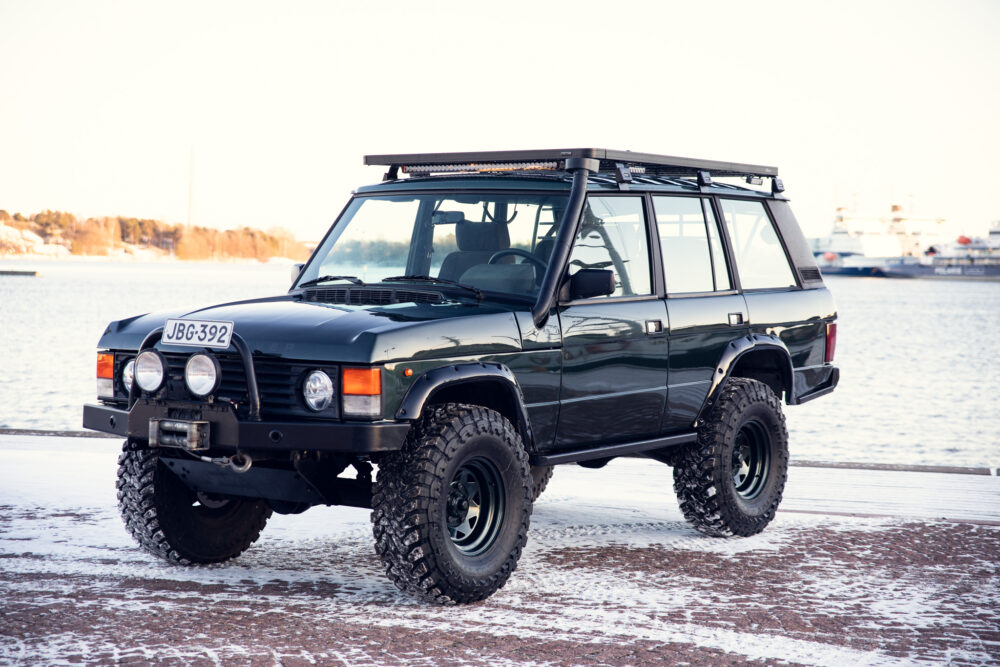 Black off-road vehicle parked by snowy waterfront
