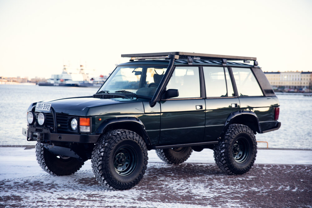 Black off-road vehicle parked by snowy waterfront