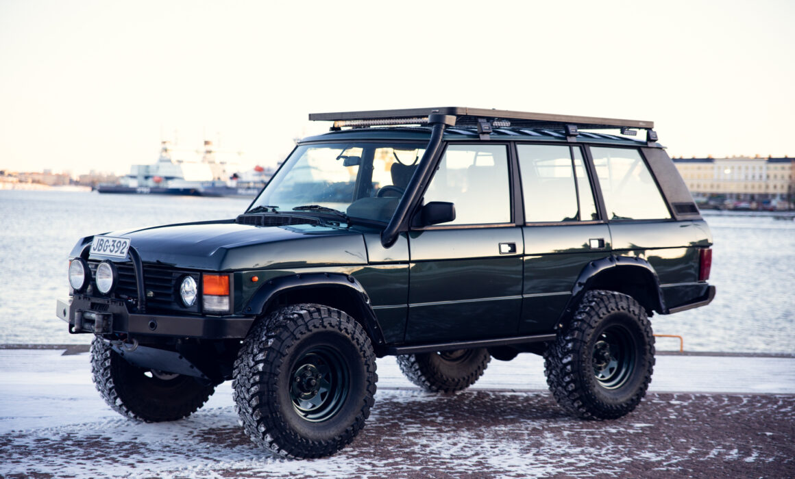Black off-road vehicle parked by snowy waterfront