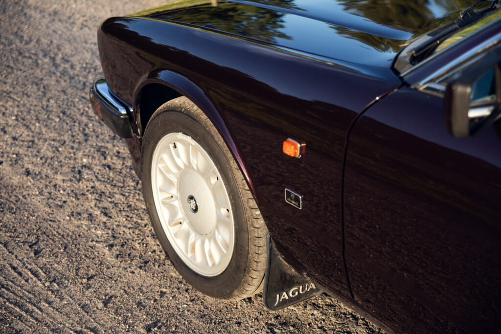 Classic Jaguar front wheel on gravel road