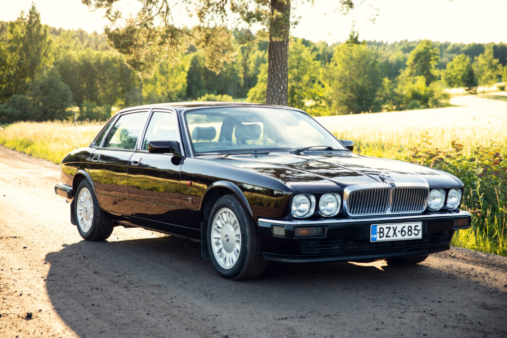 Classic black Jaguar sedan on rural country road