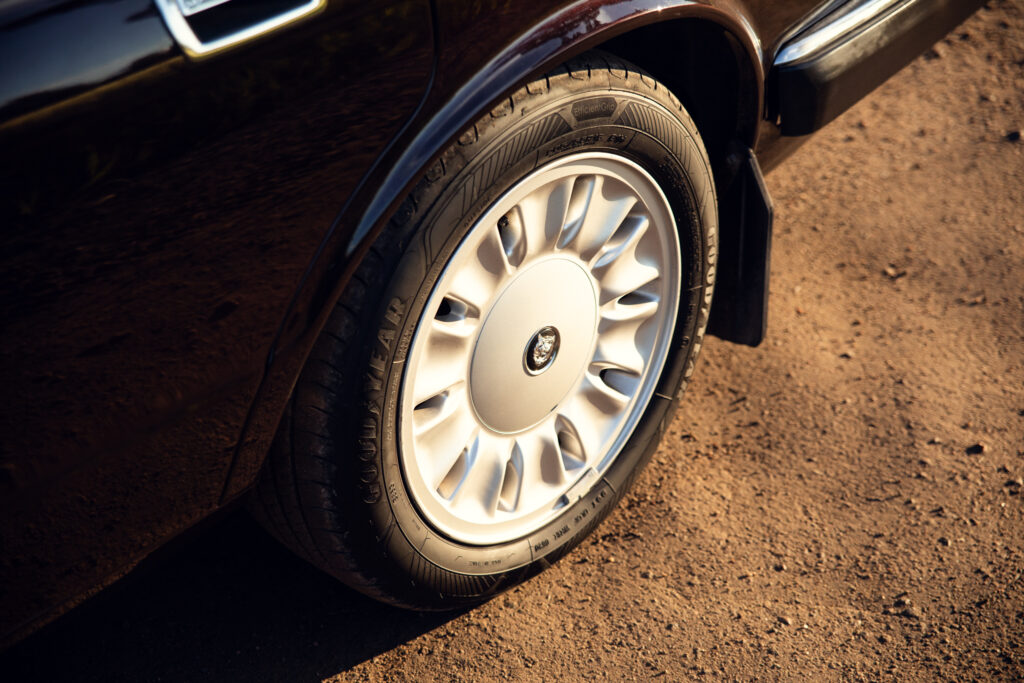 Close-up of car wheel on dirt road