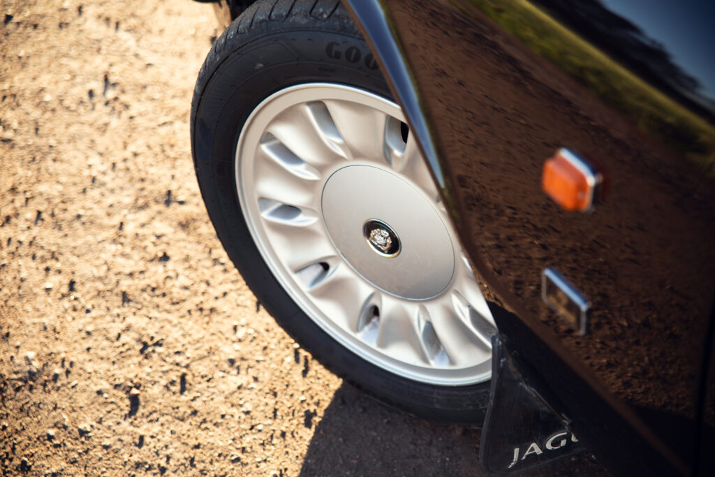 Close-up of car wheel on sandy ground