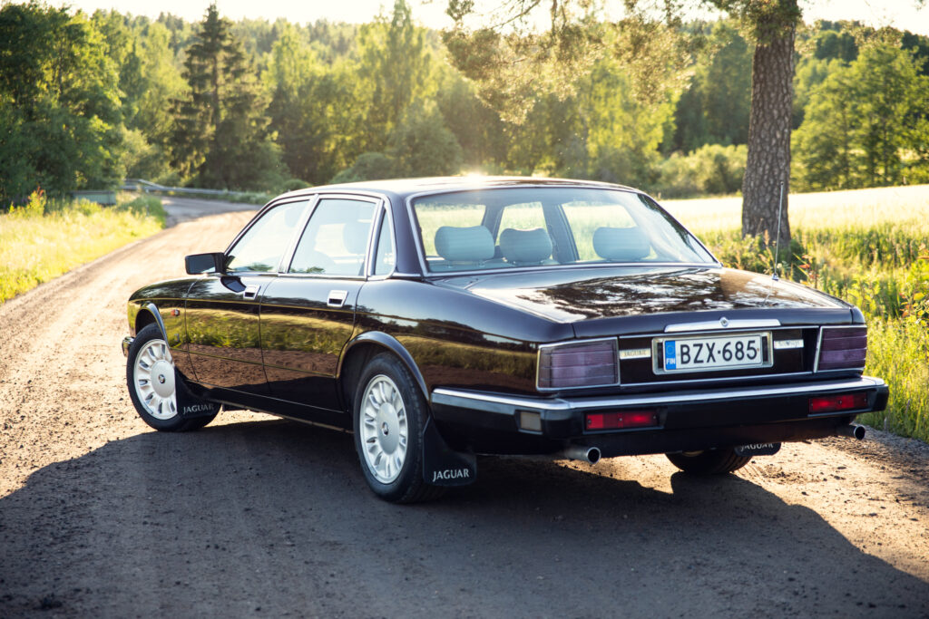 Classic black Jaguar sedan on rural road
