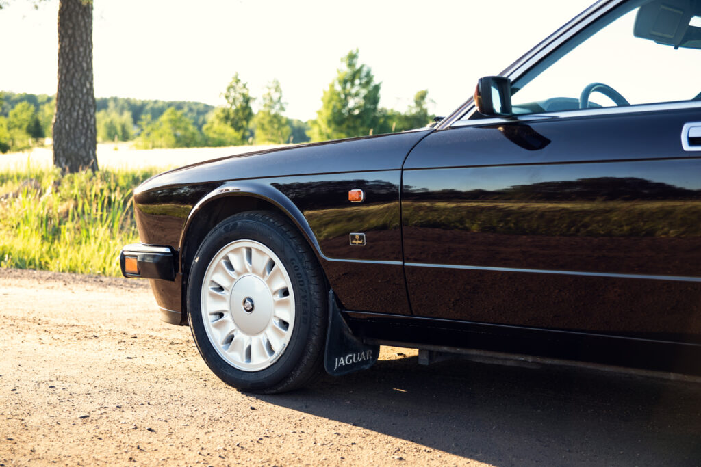 Classic black Jaguar parked on country road