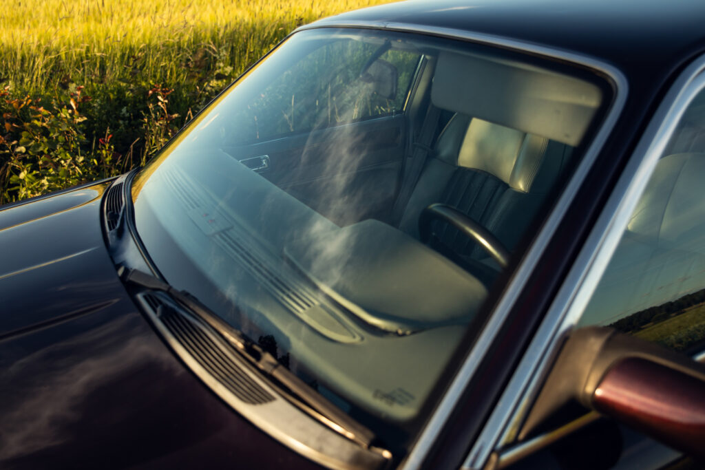 Car windshield with condensation parked near field