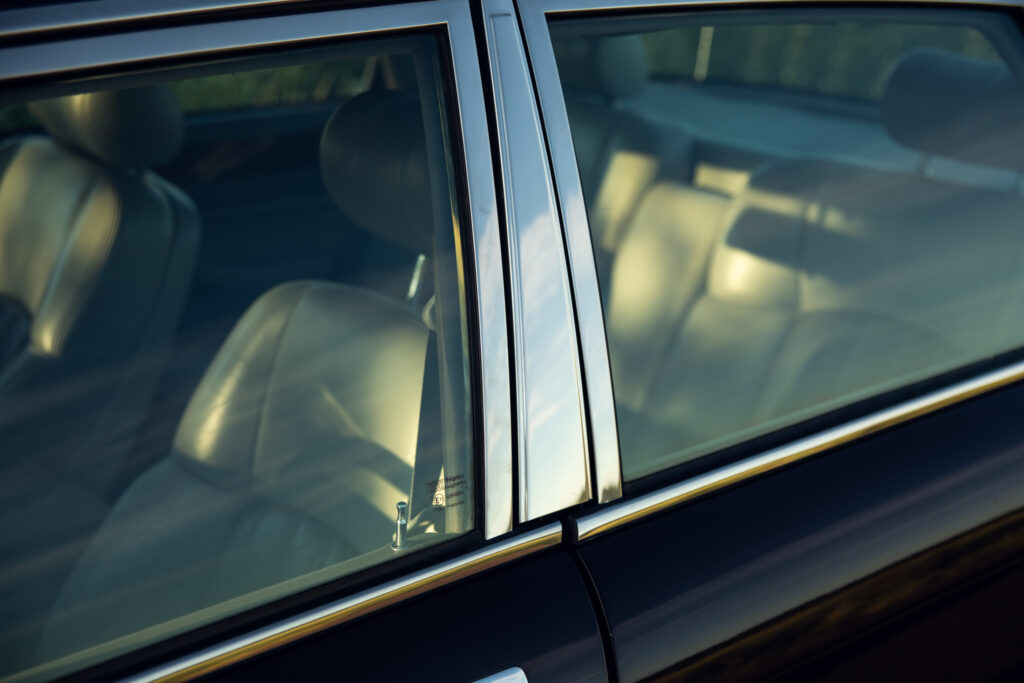 Close-up of car window and leather seats