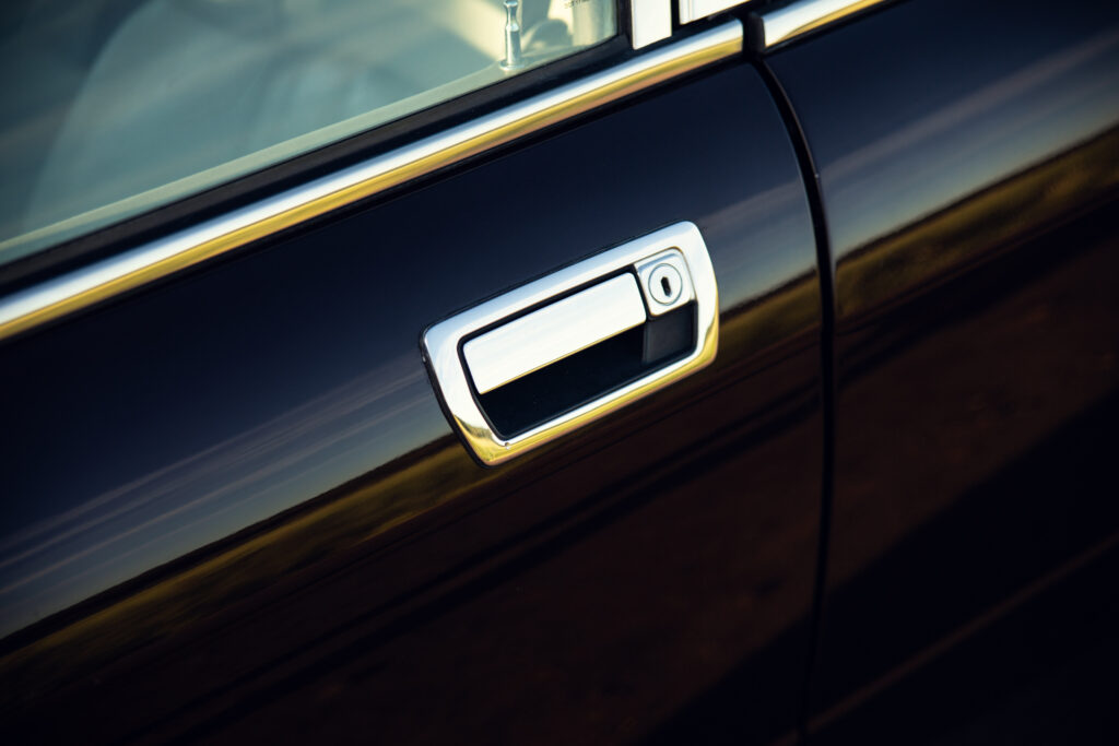Close-up of car door handle with keyhole