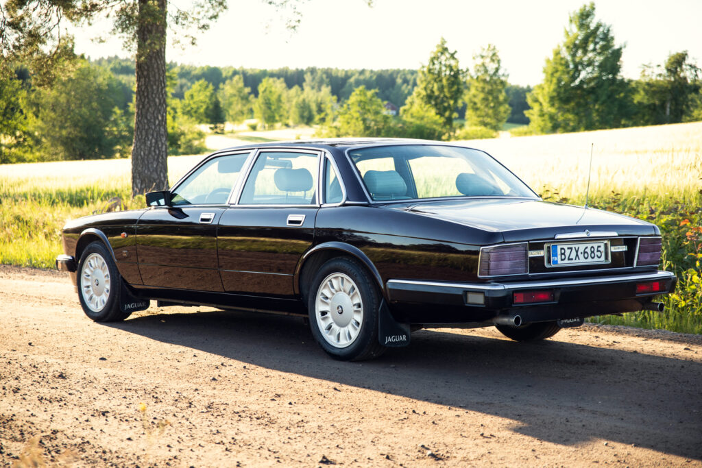 Classic black Jaguar sedan on rural road
