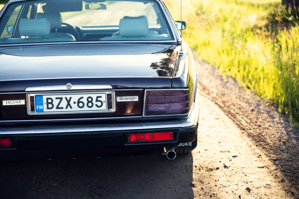 Rear view of classic Jaguar on rural road