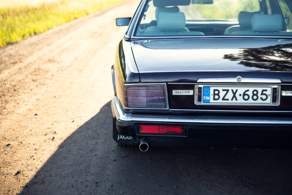 Rear view of black Jaguar on rural road
