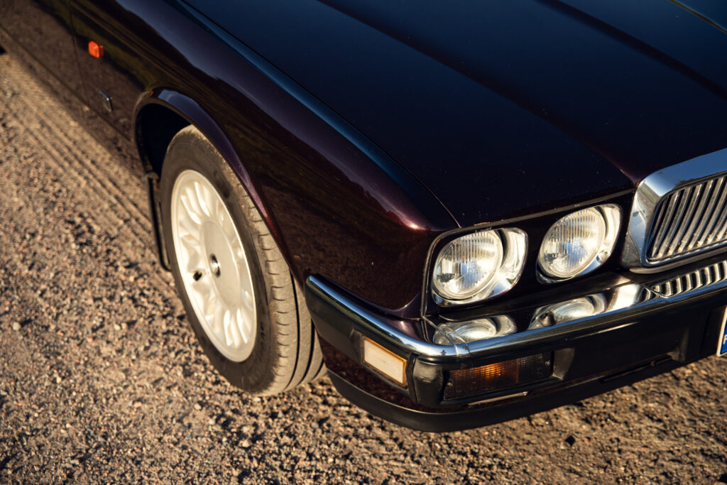 Front corner of classic sedan on gravel