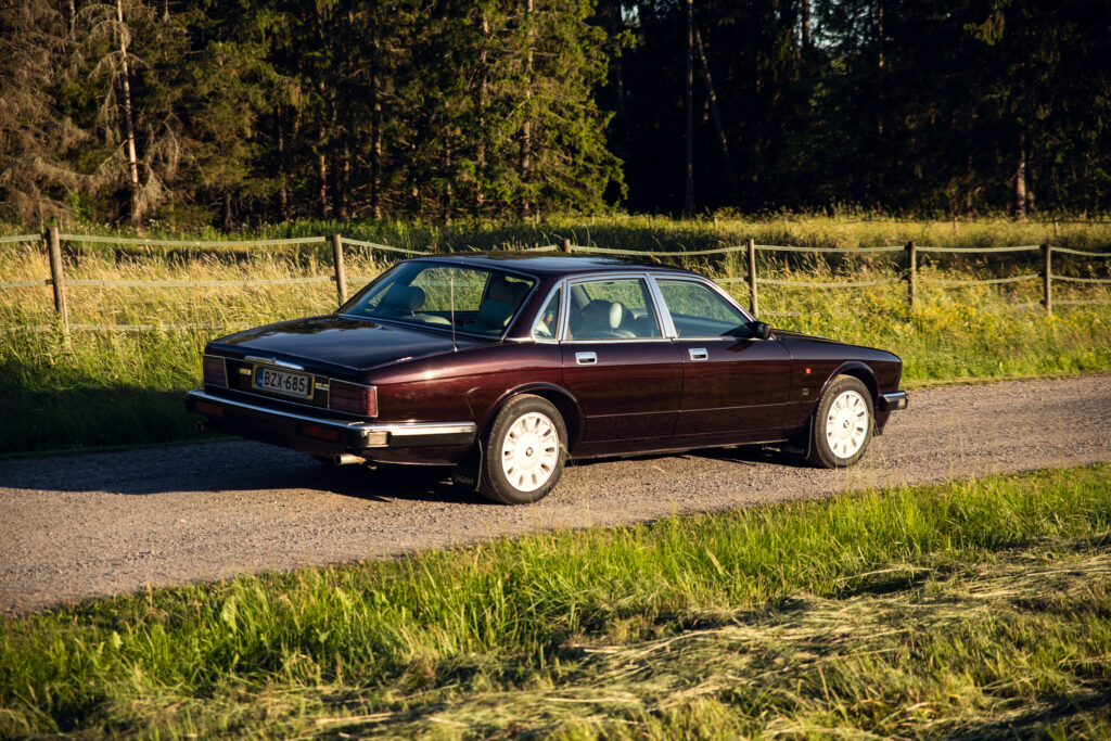 Vintage maroon sedan on rural gravel road