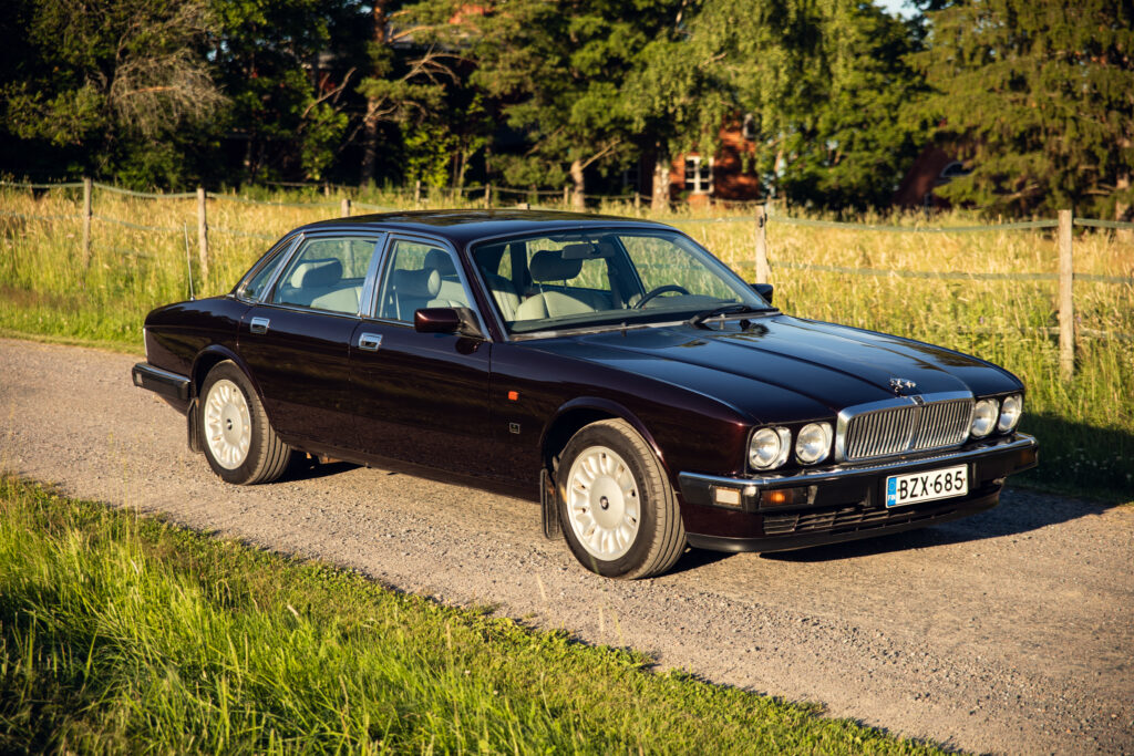 Classic black Jaguar sedan on rural road