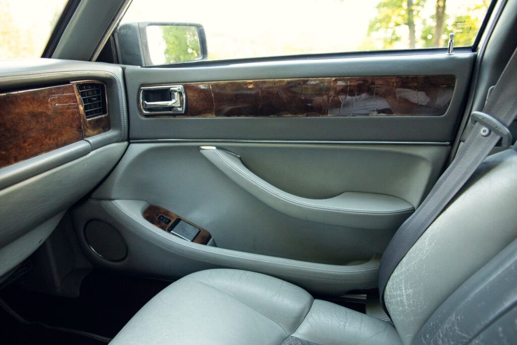 Luxury car interior with wood trim door panel
