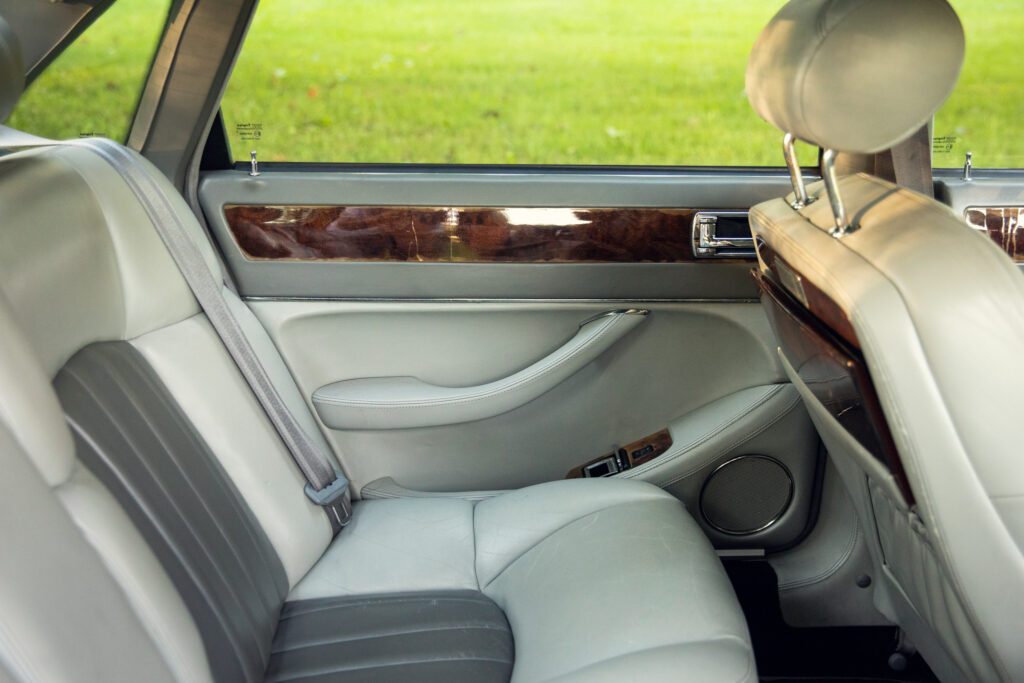 Luxury car rear seat with leather and wood trim