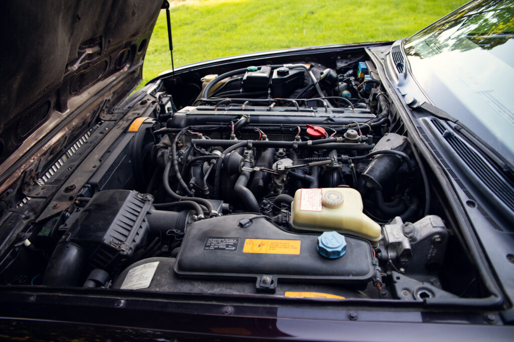 Open car hood showing engine compartment