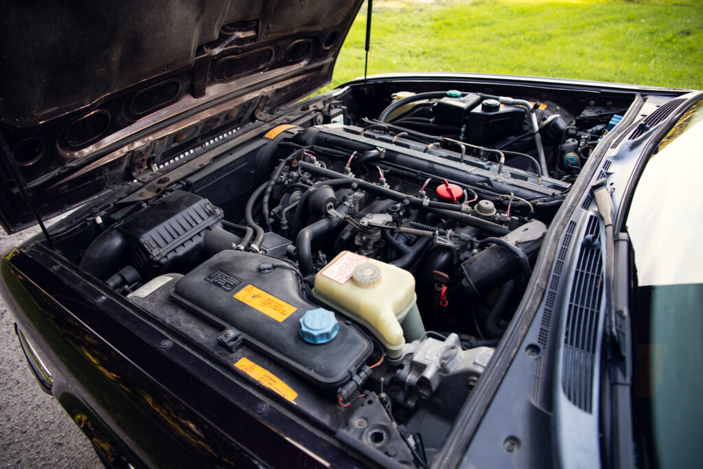 Open car hood showing engine compartment