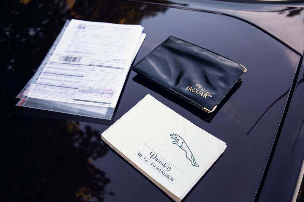Jaguar car manual and documents on hood