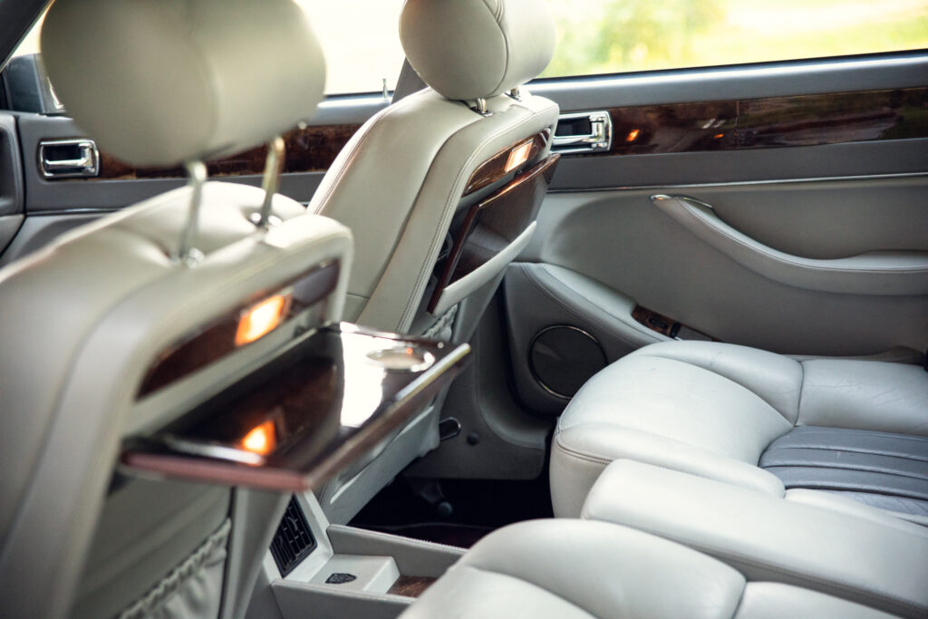 Luxury car rear seats with fold-down trays
