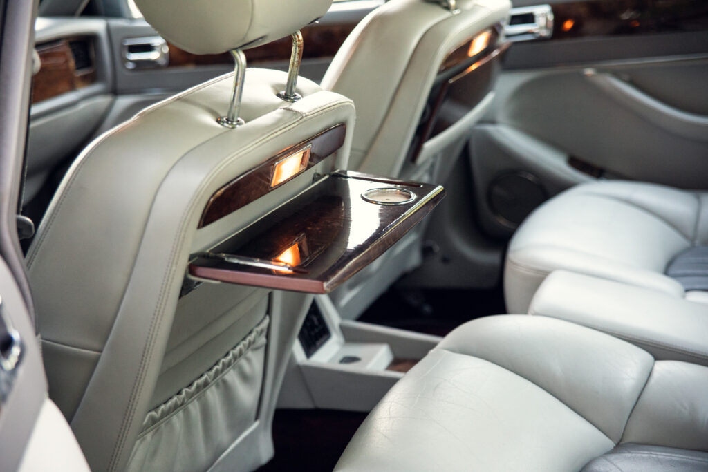 Luxury car rear seat with fold-down tray