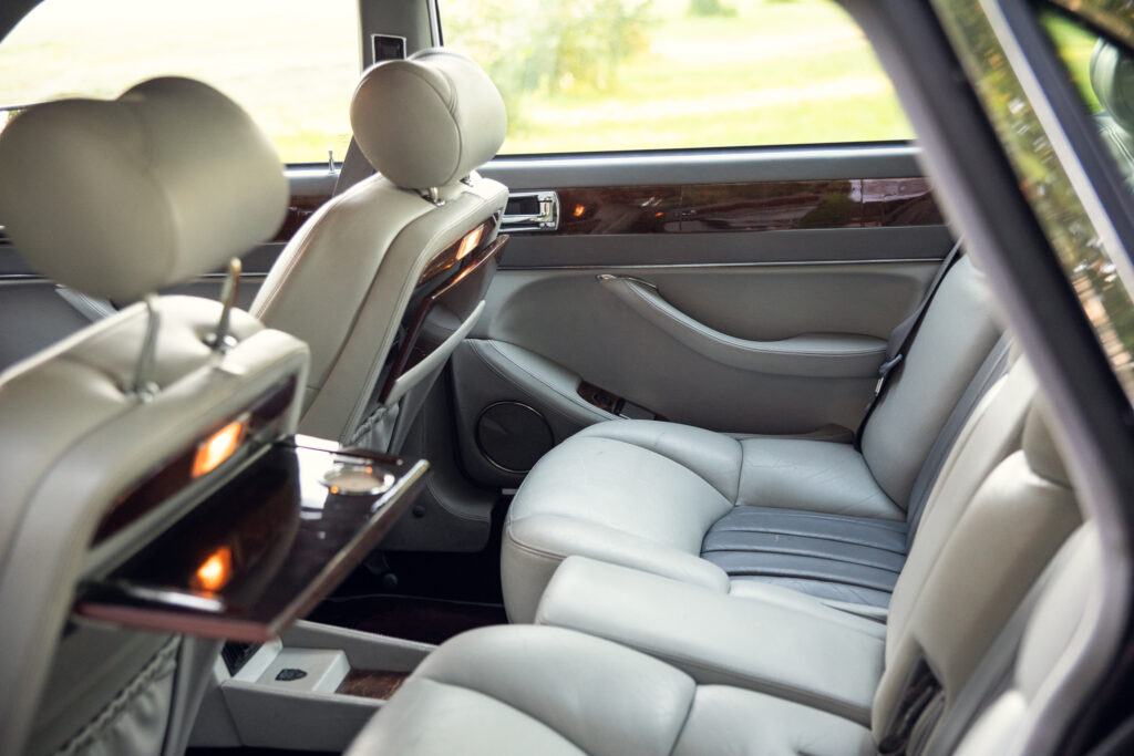 Luxury car rear seats with fold-out trays
