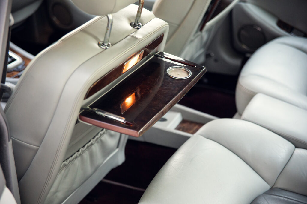 Luxury car rear seat fold-down tray table