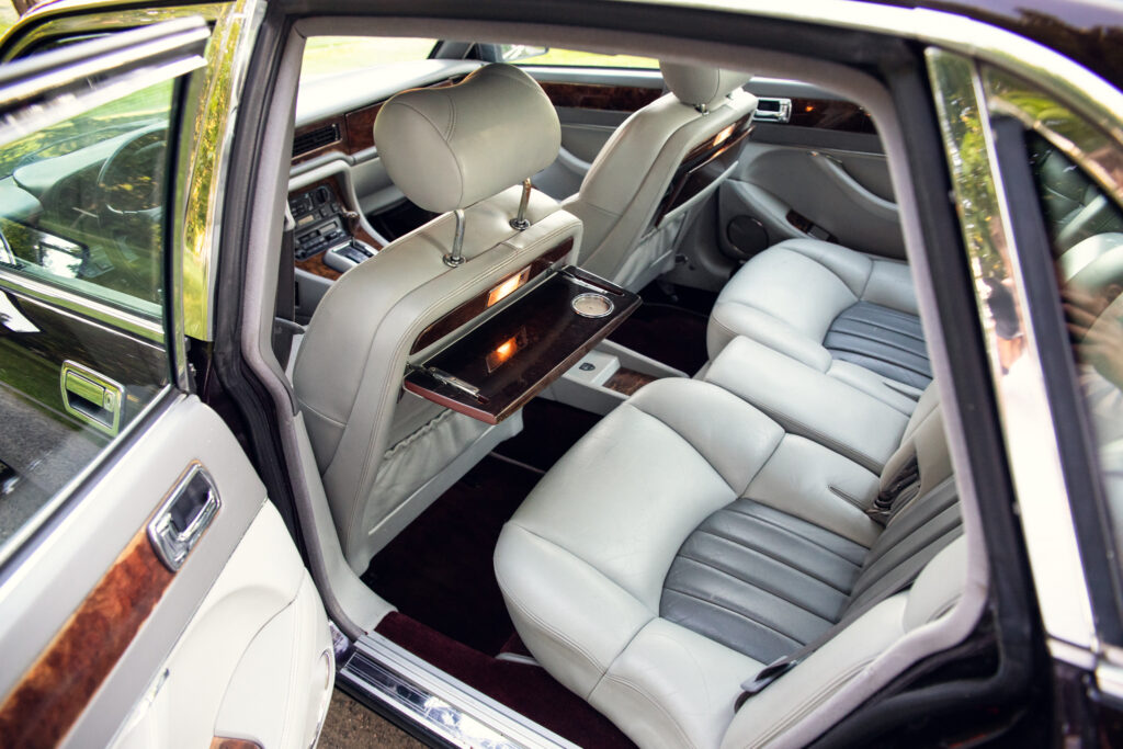 Luxury car rear seats with fold-out tray tables