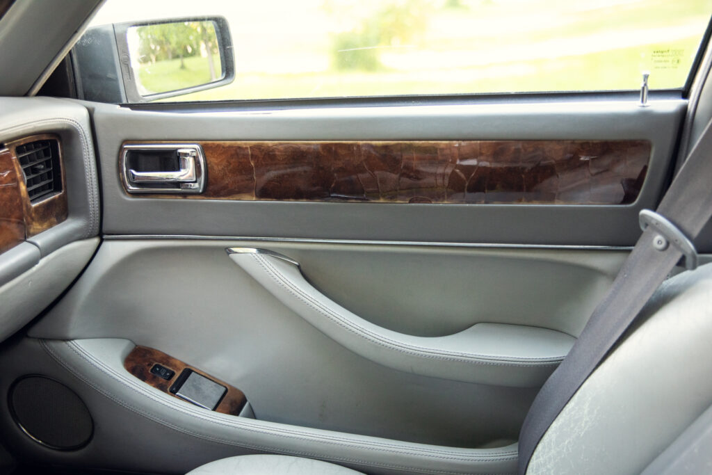 Luxury car interior door with wood trim