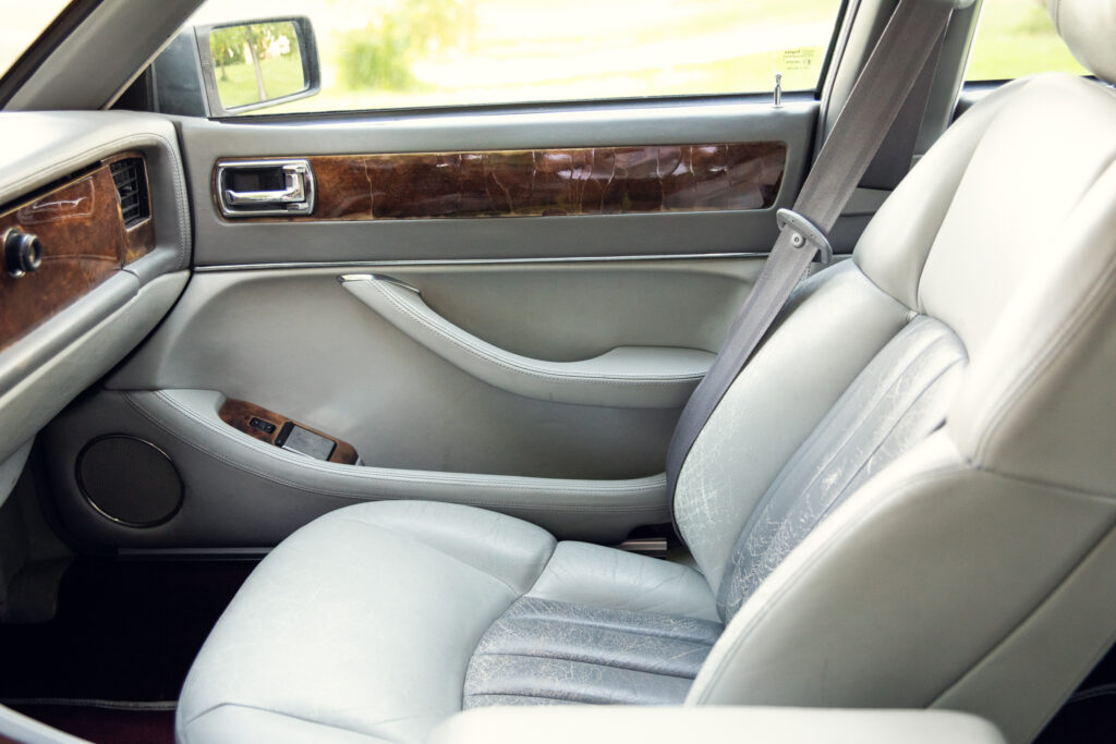 Luxury car interior with leather seat and wood trim